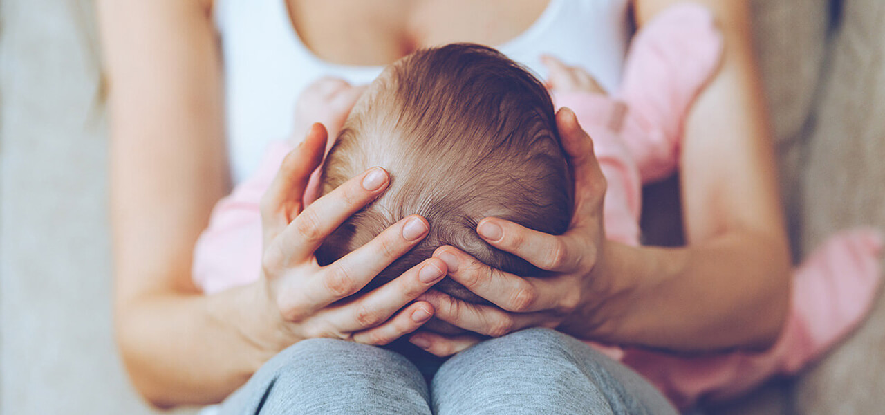 Mum Holding Baby On Knees