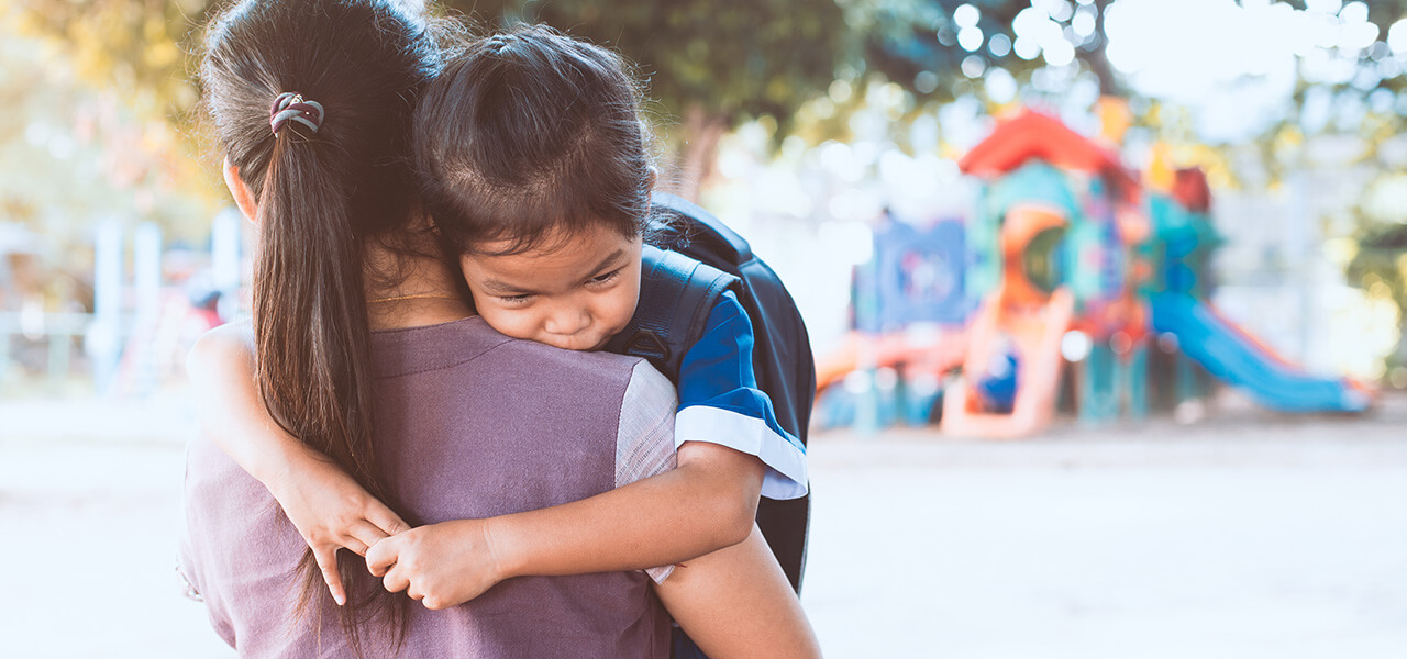 Mum Hugging Asian Girl