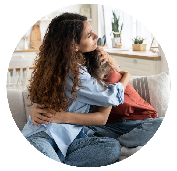 Mother hugging her child in lounge room.
